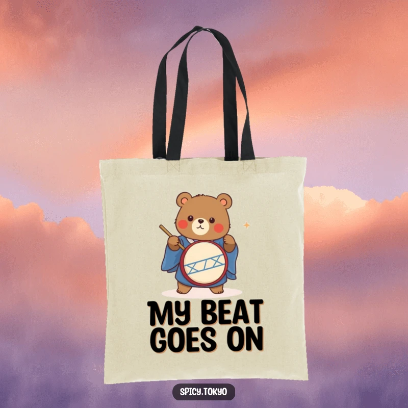 Funny cute bear in a blue kimono energetically playing a taiko drum on a tote bag.